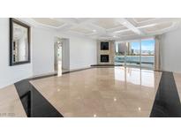 Bright living room featuring modern fireplace, floor to ceiling windows, and coffered ceilings at 2777 Paradise Rd # 303, Las Vegas, NV 89109