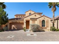 Charming two-story home featuring a tile roof, brick driveway and a two car garage at 33 Via Di Mello, Henderson, NV 89011