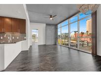 Bright living room with floor-to-ceiling windows and modern finishes, showcasing an open floor plan and city views at 353 E Bonneville Ave # 313, Las Vegas, NV 89101