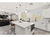Bright kitchen features a large island with a marble countertop, stainless steel appliances, and seamless access to the living room at 366 Rancho La Costa St, Las Vegas, NV 89138