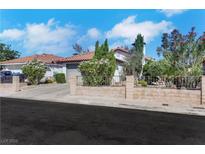 Charming single-story home featuring a tile roof, desert landscaping, and a quaint brick fence at 4629 Denwood Dr, Las Vegas, NV 89147