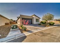 Well maintained single story home with desert landscaping, driveway, and an attached two car garage at 5091 E Beacon Ridge Dr, Pahrump, NV 89061