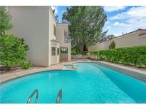 Backyard pool with a built-in spa, surrounded by lush landscaping, providing a private outdoor retreat at 5205 Coral Glow Ct, Las Vegas, NV 89149