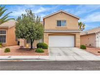 Charming two-story home featuring a tile roof, a spacious two-car garage, and mature landscaping at 682 E Sole Addiction Ave, Las Vegas, NV 89183