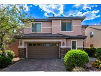 Charming two-story home with a brick driveway and lush landscaping, plus a two car garage at 7325 Perkins Hill St, Las Vegas, NV 89166