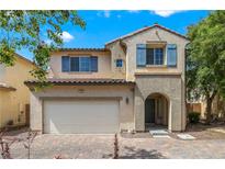 Charming two-story home with a two-car garage, desert landscaping, and blue window shutters at 928 Shades End Ave, North Las Vegas, NV 89081