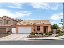 Charming single-story home featuring a well-manicured front yard and tile roof at 9329 Mountain Cliffs Ave, Las Vegas, NV 89129