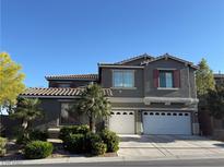 Charming two-story home with a terracotta tile roof, two-car garage, and low-maintenance landscaping at 10009 Madison Walk Ave, Las Vegas, NV 89149