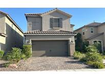 Charming two-story home featuring a tile roof, neutral stucco, and a well-maintained brick paver driveway at 1433 Overseer Ave, Henderson, NV 89074
