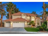 Stunning two-story home with a three-car garage, well-manicured lawn, and desert landscaping at 1990 Freeman Ct, Henderson, NV 89014