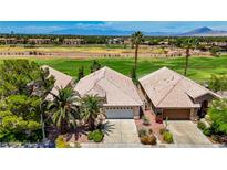Charming single-story home features lush landscaping, mature trees, and a tile roof against a green golf course at 2149 Eaglepath Cir, Henderson, NV 89074