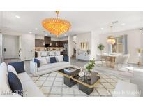 Bright living space with modern finishes, an ornate chandelier, and dining area with contemporary design at 2407 Ridgeline Wash St, Las Vegas, NV 89138