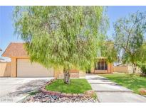 Charming single-Gathering home showcasing a spacious front yard, inviting landscaping, and classic architectural details at 2614 Capistrano Ave, Las Vegas, NV 89121