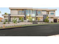 Stunning modern home with a multi-level facade, beautiful landscaping, and large windows at 2695 Ponte Vecchio Ter, Henderson, NV 89052