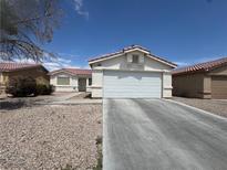 Charming single-story home featuring a two-car garage and low-maintenance desert landscaping at 2916 Honeysuckle Ave, North Las Vegas, NV 89031