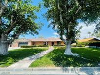 Charming single-story brick home with a beautifully landscaped front yard and inviting walkway at 3104 Conners Dr, Las Vegas, NV 89107