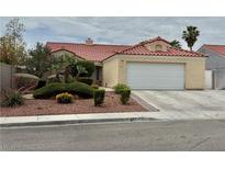 Charming single-story home with a red tile roof, neutral stucco, and well-manicured landscaping at 4013 Extenso Dr, North Las Vegas, NV 89032
