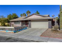 Charming single-story home showcasing a two-car garage, xeriscaping, and desert landscaping at 5132 Springland St, Las Vegas, NV 89146