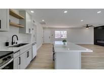 Beautiful kitchen featuring white cabinets, stainless steel appliances and a center island at 6100 Fawn Cir, Las Vegas, NV 89107