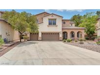 Charming two-story home with a three-car garage, stone accents, and a well-maintained front yard at 1155 Phillip Island St, Henderson, NV 89052