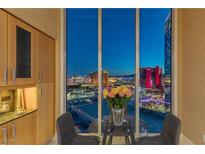 Modern dining area with stunning city views through floor-to-ceiling windows, complemented by stylish cabinets at 2747 Paradise Rd # Ph 3604, Las Vegas, NV 89109
