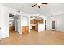 Open floor plan with wood floors leading to the kitchen and bathroom and ceiling fan for comfort at 4655 Gold Dust Ave # 210, Las Vegas, NV 89120