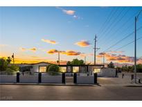 Charming single-story home with a manicured front yard under a beautiful sunset sky at 517 N 22Nd St, Las Vegas, NV 89101