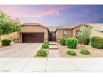 Charming single-story home featuring a well-manicured front yard and a two-car garage at 5616 Silver Cascade Ave, Las Vegas, NV 89131