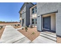 Charming townhome featuring a modern facade, neat landscaping, and a welcoming front entrance at 6188 Hibiscus Garden St # 174, North Las Vegas, NV 89081