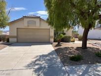 Charming one-story home featuring a well-maintained front yard, desert landscaping, and an attached two-car garage at 732 Goshawk St, Henderson, NV 89015