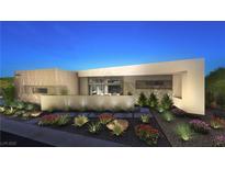 Modern home exterior features a clean design, neutral color palette, and professionally landscaped front yard at 7349 Olive Creek Ct, Las Vegas, NV 89117