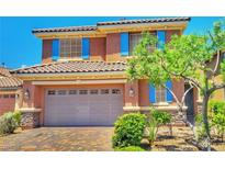 Charming two-story home featuring a tile roof, blue shutters, and a well-maintained front yard at 10279 Montes Vascos Dr, Las Vegas, NV 89178
