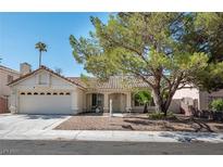 Charming single-story home with a two-car garage, desert landscaping, and mature shade tree at 1502 Cliff Branch Dr, Henderson, NV 89014