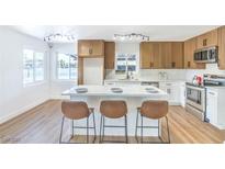 Beautiful kitchen features a spacious island, stainless steel appliances and white cabinets at 1600 E Mcdonald Ave, North Las Vegas, NV 89030