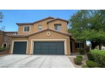 Two-story home featuring a neutral color palette, tiled roof, and attached two-car garage at 1777 Gentle Brook St, North Las Vegas, NV 89084