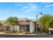 Modern home featuring clean lines, neutral tones, and desert landscaping for a sleek, contemporary look at 21 Highland Cove Ln, Henderson, NV 89011