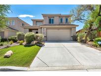 Charming two-story home with a well-maintained lawn, desert landscaping, and a two-car garage at 2449 Daks Loden Ct, Henderson, NV 89044