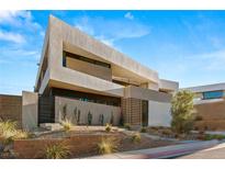 Striking modern home featuring a unique architectural design and desert landscaping at 25 Canyon Bay Dr, Henderson, NV 89011