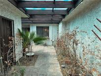 Enclosed courtyard with brick pavers, garden, and wood beam pergola offers a private outdoor space at 2544 Malabar Ave, Las Vegas, NV 89121