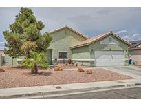 Charming single-story home featuring desert landscaping, attached garage, and neutral toned stucco exterior at 4318 Scarlet Vista Ct, North Las Vegas, NV 89031