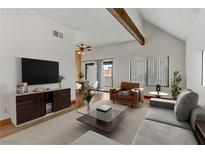 Bright living room features modern furnishings, neutral tones, and a sliding glass door at 4391 Gannet Cir # 16, Las Vegas, NV 89103