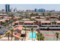 An aerial view of a residential area, with a pool, tennis court, and downtown in the background at 4421 Alexis Dr # 429, Las Vegas, NV 89103