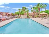 Beautiful community swimming pool with lush landscaping and ample lounging space on a sunny day at 4421 Alexis Dr # 429, Las Vegas, NV 89103