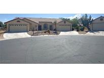 Charming single-story home with a two-car garage and desert landscaping at 4833 Lawnwood Ct, Las Vegas, NV 89130