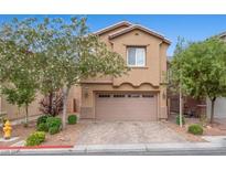 Charming two-story home with a well-manicured yard and attached two-car garage at 7345 Chesapeake Cove St, Las Vegas, NV 89166