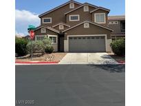 Two-story home with a two-car garage, neutral paint and desert landscaping at 9145 Sunken Meadow Ave, Las Vegas, NV 89178
