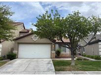 Charming single-story home with a well-maintained lawn, mature tree, and two-car garage at 10321 Birch Bluff Ln, Las Vegas, NV 89145