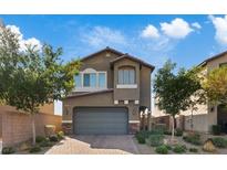 Charming two-story home features a well-manicured lawn and an attached two-car garage, perfect for Gathering living at 1266 Smokey Valley Ln, Henderson, NV 89002