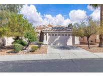 Charming single-story home with a two-car garage, desert landscaping, and a welcoming entrance at 2271 Smokey Sky Dr, Henderson, NV 89052