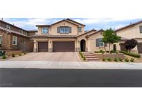 Charming two-story stucco home features a three-car garage and well-manicured landscaping at 2575 Hazelburn Ave, Henderson, NV 89044